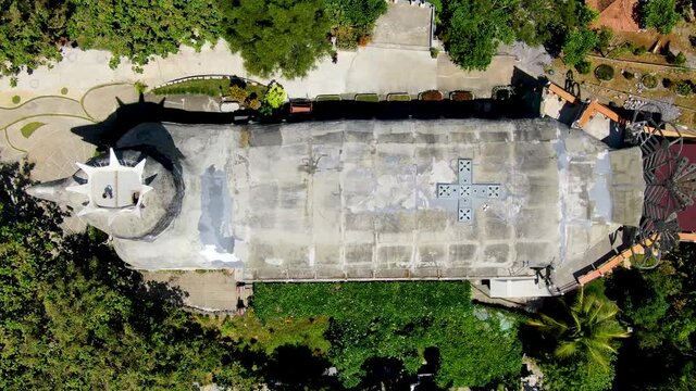 Chicken church of Magelang with green forest around, aerial top down view