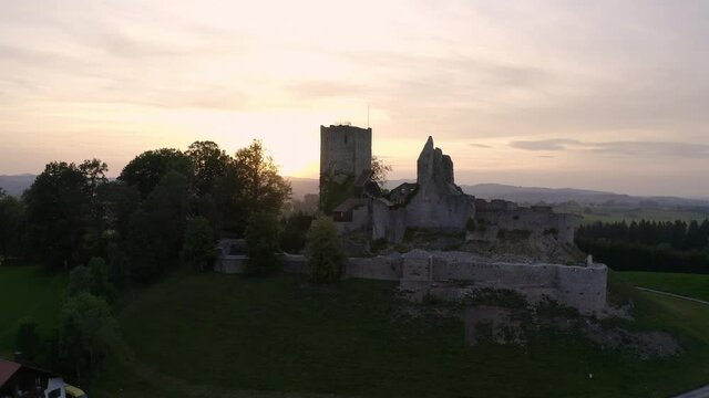 Aerial view around the Burgruine Sulzberg sunset in Bavaria, Germany - orbit, drone shot