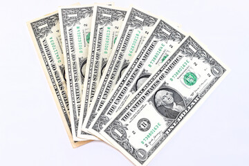 One dollar bills lie fanned out on a white background. Money background. Top view, flat lay. Selective focus.
