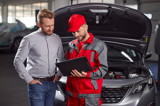 Car mechanic and client in repair service