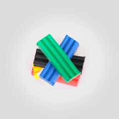 Stack of pieces of multicolored plasticine isolated on white background