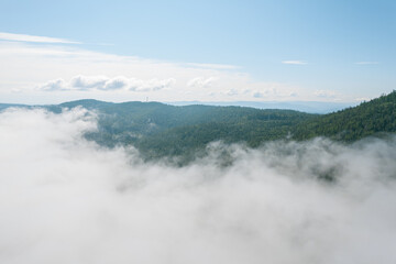 Flying through the clouds above mountain tops. High peaks wonderful morning sunrise natural Landscape