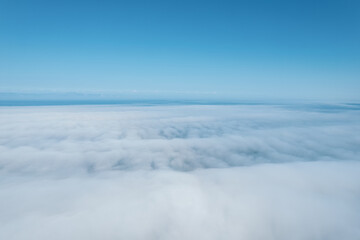 Flying through the clouds above mountain tops. High peaks wonderful morning sunrise natural Landscape
