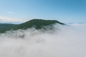 Flying through the clouds above mountain tops. High peaks wonderful morning sunrise natural Landscape