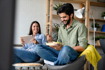 Young happy couple having a good time together in a cozy home