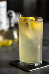 Luxury cocktail with lemon and tequila on a dark stone background