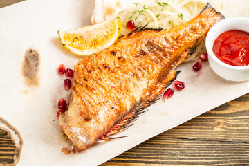 sea bass grill. Serving on a wooden Board on a rustic table. Barbecue restaurant menu, a series of...
