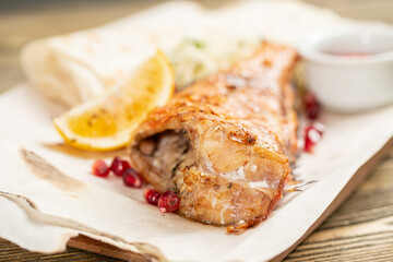 sea bass grill. Serving on a wooden Board on a rustic table. Barbecue restaurant menu, a series of photos of different meats