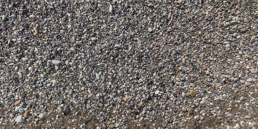 Wall mural panorama view from above on surface of small pebbles on the sea coast