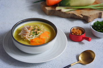 a bowl of  yellow chicken soup