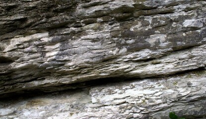 Texture of gray limestone rock with cracks