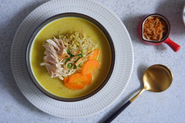 a bowl of  yellow chicken soup