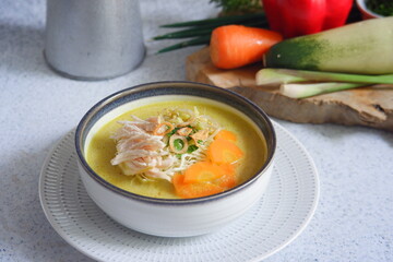 a bowl of  yellow chicken soup