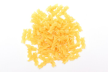 A Heap of Uncooked Fusilli Pasta Scattered on White Table. Raw and Dry Macaroni. Unhealthy and Fat Food. Italian Culture