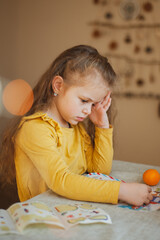 Cute little girl writes a letter to Santa Claus. Christmas concept
