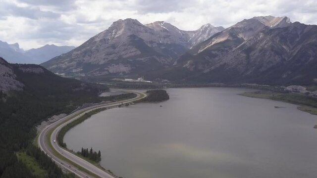 TransCanada Highway passes mountain lake, industrial plant in Rockies