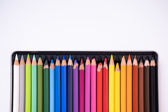 Colored pencils in a box on a white background. High quality photo