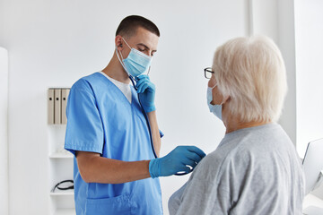 elderly woman next to the doctor vaccine passport immunity protection