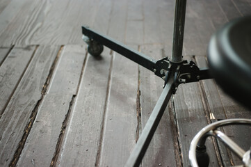 A tripod on the wooden floor.