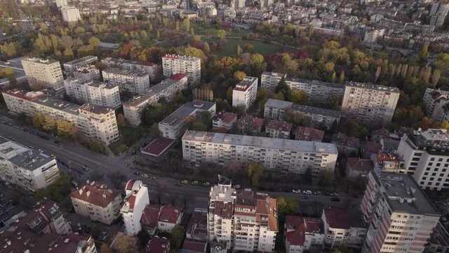 Urban view of living houses and parks with colorful autumn tree tops