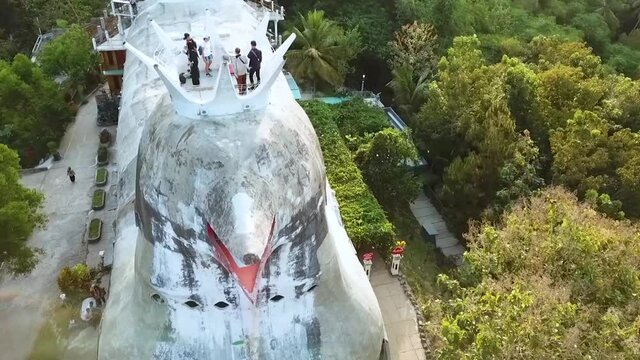 Tourists enjoys view from chicken style church building in Indonesia, aerial view