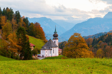 Church of Maria Gern in the mountains in the background with the Watzmann mountains in autumn colors at sunset, Bavaria, Berchtesgaden