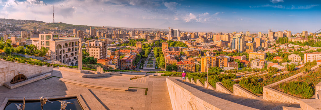 Panoramic view from the stairs of Cascade monument to the colorful sunrise over roofs of Yerevan city and symbol of Armenia - Mount Ararat