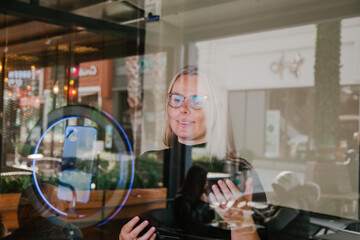 Young influencer in front of the camera and selfie ring light reading a text . SMM manager.