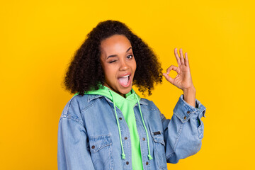 Photo of funny beautiful african lady dressed jeans green hoodie smiling winking showing okey...