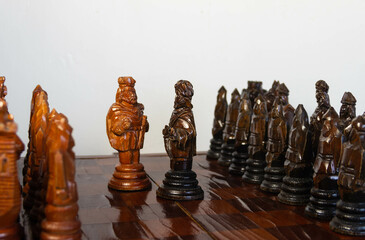 a chessboard with pawns and pieces lined up, two kings stand in front of the rows