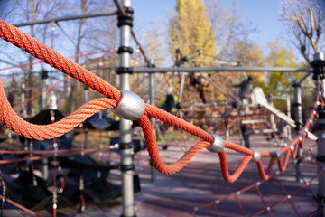 Children's playground for active games. A slide of ropes as a device for climbing up. Close-up of cables and ropes