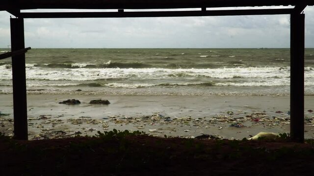 mui ne after a huge typhon during october. in south china sea. piles of rubish waste at sea