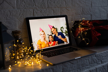 Image of open laptop family and christmas on wooden table in front of christmas tree background