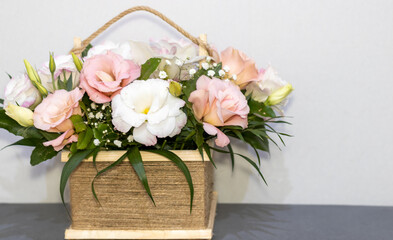 Flower arrangement in Wicker basket. Beautiful bouquet of mixed pastel color flowers on window sill or sofa edge.flower shop, wedding, Flowers delivery. Space for text.mother women international day