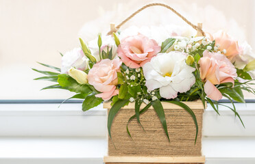 Flower arrangement in Wicker basket. Beautiful bouquet of mixed pastel color flowers on window sill or sofa edge.flower shop, wedding, Flowers delivery. Space for text.mother women international day