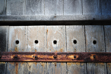Close Up of Ancient Wooden Door with Holes & Old Rusty Hinge 