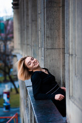 Fototapeta premium Young woman on the city balcony