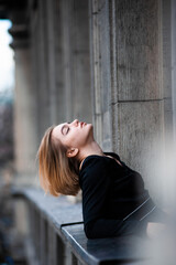 Fototapeta premium Young woman on the city balcony
