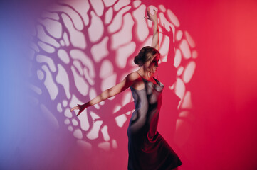 beautiful girl in a dress, blonde hair, dancing on a colored background with a pattern