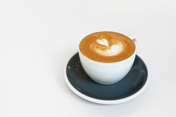 Cup of fresh coffee on white background. Delicious morning cappuccino with latte art on table. Front view, copy space.