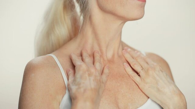 Anonymous Senior Woman Touching Her Neck, Chest, with Sensual Movement of Hands, Enjoying Soft Skin. Elderly Female Natural Beauty. Dignity and Grace in Old Age. Concept for Skin care, Healthy Living