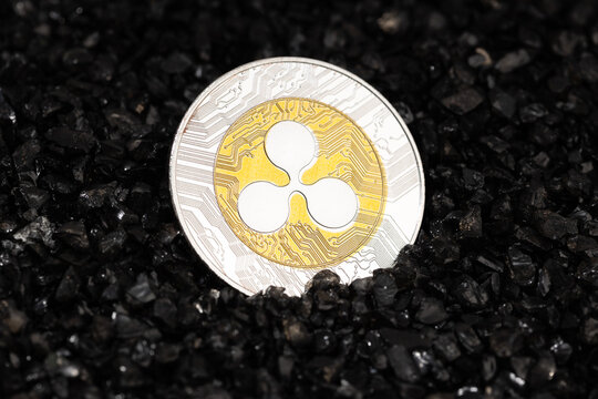 Ripple XRP coin on black gravel background. Cryptocurrency blockchain money