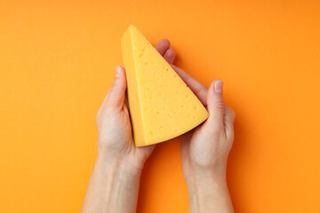 Concept of cooking eating with hard cheese on orange background