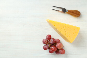 Concept of cooking eating with hard cheese on white wooden background