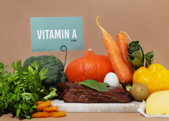 A set of natural products rich in vitamin A retinol. Healthy food concept. Cardboard sign with the...