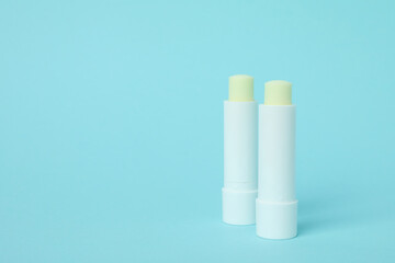 Eco lipstick on blue background, space for text