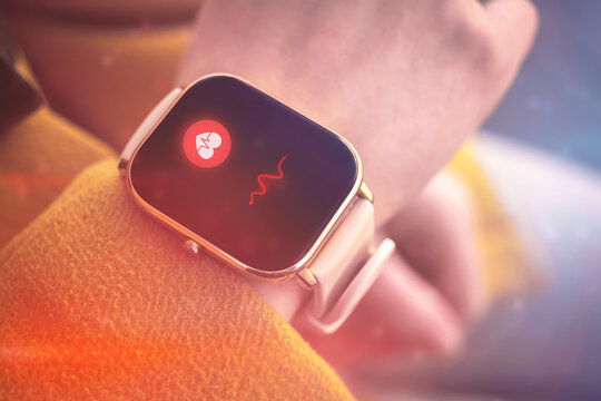 Woman check the pusle with application on smart watch. Closeup heart rate icon, healthcare concept photo