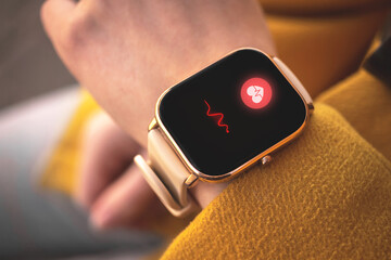 Smart watch with heart rate icon, healthcare concept. Woman measuring heart rate with application