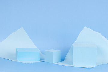 Abstract monochrome composition with empty rectangular podium platform for product presentation and torn paper edges on light blue background. Front view