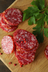 Сoncept of tasty food with salami sausage on wooden background